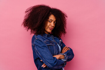 Young african american woman isolated on pink background unhappy looking in camera with sarcastic...