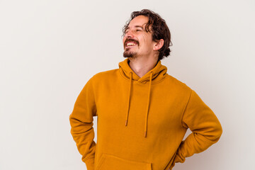 Young caucasian man isolated on white background relaxed and happy laughing, neck stretched showing teeth.