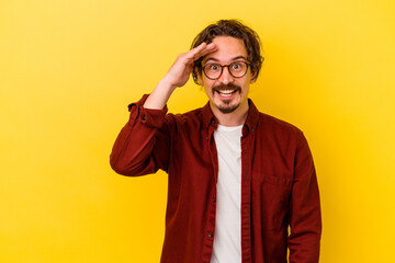 Fototapeta premium Young caucasian man isolated on yellow background shouts loud, keeps eyes opened and hands tense.