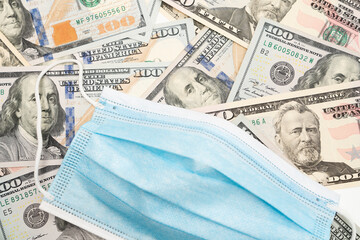 Cost of healthcare/Covid-19 concept with surgical mask and US currency