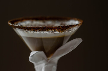 Coffee cocktail with a nutty note with fluffy milk foam, decorated with shavings of chocolate, served with an Easter bunny-shaped napkin