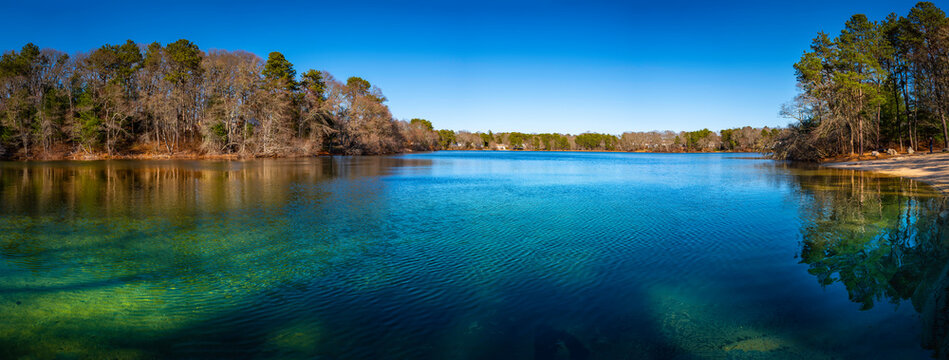 Panoramic Image of Picture Lake Forest and Transparent Clean Turquoise Colored Water. Pristine Water Reflections of Tree Shadows. Beautiful Springtime Kettle Pond Landscape on Cape Cod, Massachusetts.