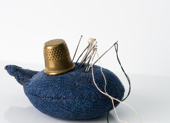 spool of thread needles and are on the table