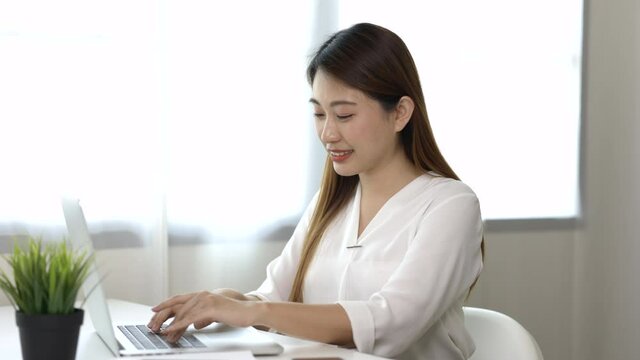 Young Beautiful Asian Business Woman Finish Working And Stretch Oneself. Women Finished Work And Rest She Works At Home In The Living Room.