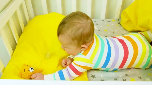 baby plays in the crib. selective focus.