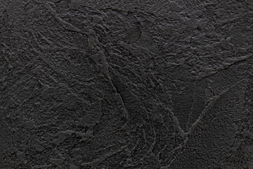 Designed dark (black) stucco background (plastered wall texture).