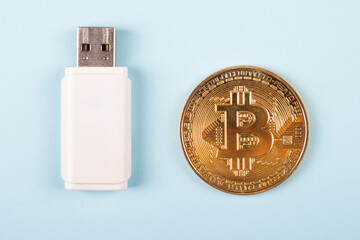 gold coin cryptocurrency bitcoin with USB stick close-up, security key, encrypted storage as a...