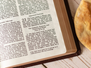 God festivals Holy Days Passover Days of Unleavened Bread opened Holy Bible wooden background...