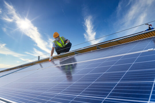 technician checking the maintenance of the solar panels on roof, solar energy