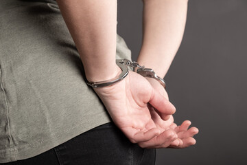 arrested human with handcuffed hands close-up, law and justice concept