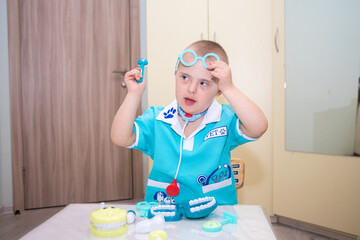 A boy with Down's syndrome plays a role-playing game, a genetically ill disabled child dressed as a...