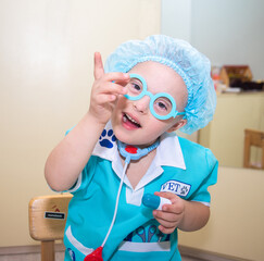 A boy with Down's syndrome plays a role-playing game, a genetically ill disabled child dressed as a...