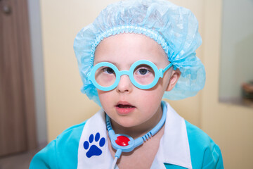 A boy with Down's syndrome plays a role-playing game, a genetically ill disabled child dressed as a...