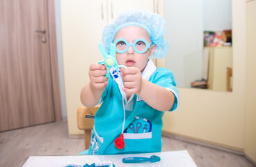 A boy with Down's syndrome plays a role-playing game, a genetically ill disabled child dressed as a...