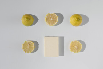 Close-up fresh slice lemon fruit and soap bar on white background. Pattern. Top view with copy space. Set of multiple images. Part of series