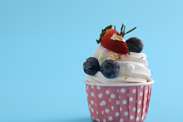 Fruits cupcake isolated in blue background