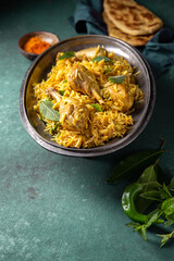 Chiken biryani Rice with yogur and mint on metal, top view. Pakistani and indian dish