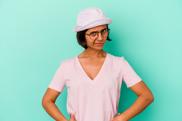 Young mixed race woman isolated on blue background confused, feels doubtful and unsure.