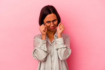 Young mixed race woman isolated on pink background whining and crying disconsolately.