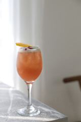 Pink Cocktail glass with ice at gray table