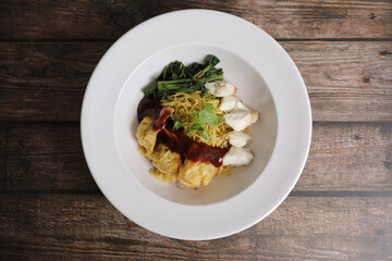 Shrimp dumpling noodles and crab meat on wood background