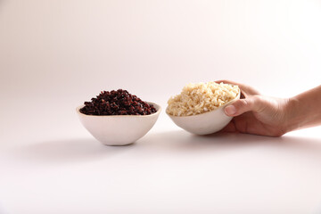 Organic boiled brown rice on bowl isolated in white background