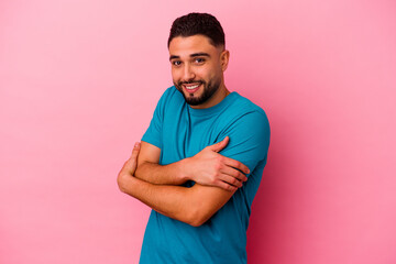 Young mixed race man isolated on pink background