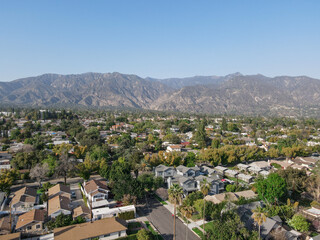 Fototapeta na wymiar Aerial view above Pasadena neighborhood with mountain in the background. northeast of downtown Los Angeles, California, USA