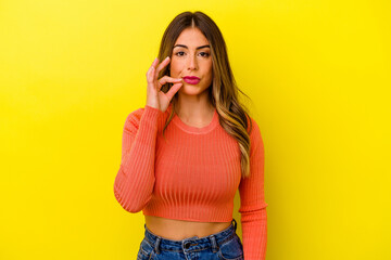 Young caucasian woman isolated on yellow background