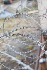 Barbed wire wall. Security barbed wire on a low fence