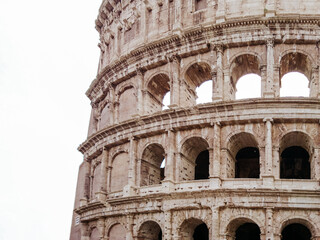 Colosseum marble arches part view on white background. Iconic ancient monumental 3-tiered Roman amphitheater, gladiatorial games arena in center of Rome, Italy