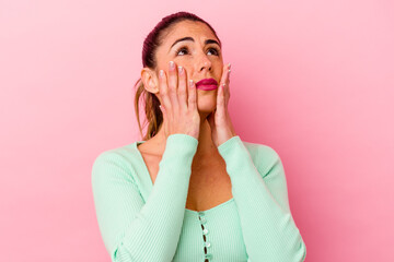 Young caucasian woman isolated on pink background