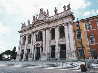 Basilica di San Giovanni in Laterano with ornate white 1700s facade and statues of the Apostles on top in Rome, Italy. Landmark cathedral, the Pope's official seat