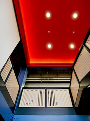 modernly decorated building interior with red ceiling