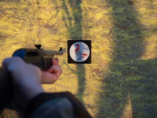 a man aims an air rifle at a target for shooting.