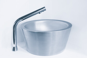 Luxury infrared vandal-proof stainless steel faucet and sink. Sanitary prevention antivirus concept.