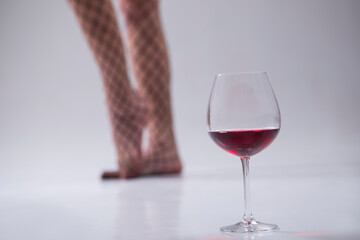 glass of wine. Sexy woman legs. Sensual. Red wine. 
