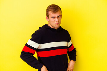 Young caucasian man isolated on yellow background