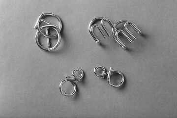 The Wire puzzle (Puzzle ring) on a grey background