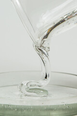 Macro shot of glue or streaming light transparent liquid