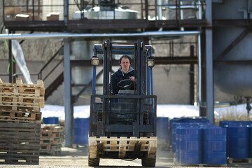 The forklift driver rides among the pallets on the production and trade bays.