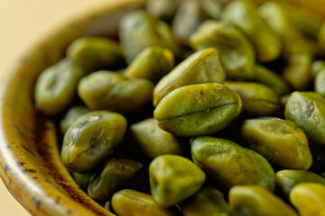 Close up of green pistachios in a bowl