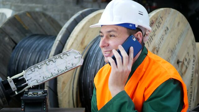 Helmet engineer talking on a cell phone.