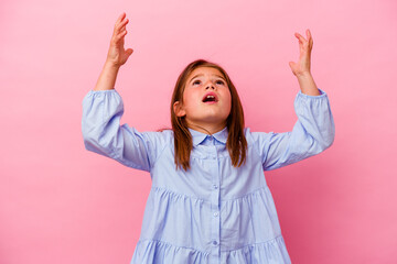 Little caucasian girl isolated on pink background  screaming to the sky, looking up, frustrated.