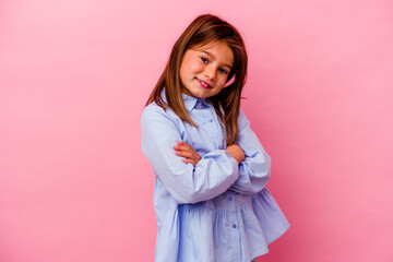 Little caucasian girl isolated on pink background  who feels confident, crossing arms with...
