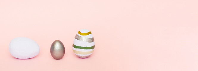 Easter composition of light blue, gray, pastel colors of decorative eggs on a pink pastel paper background. Easter concept..