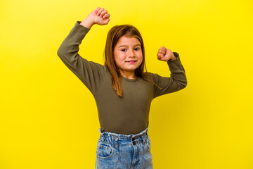 Little caucasian girl isolated on yellow background celebrating a special day, jumps and raise arms...