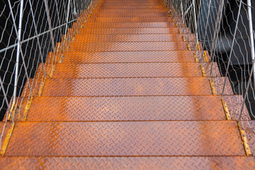 rusty wet metal staircase leading down, stairs down to darkness, fear, danger, space for text