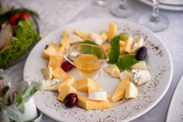Slicing different types of cheese and olives. Buffet