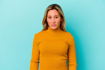 Young mixed race woman isolated on blue background sad, serious face, feeling miserable and...